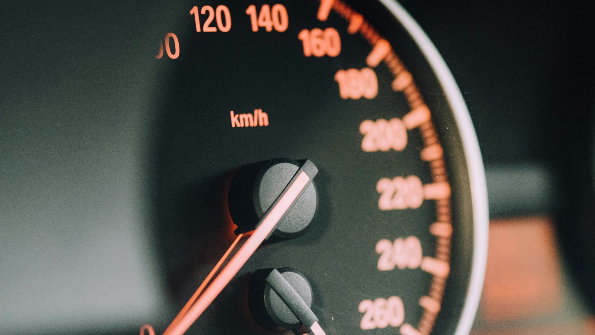 closeup photo of black analog speedometer